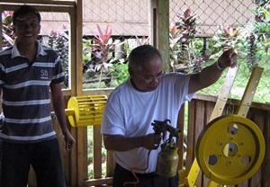 Cardinal Quevedo helps paint turbines in rural Philippines.